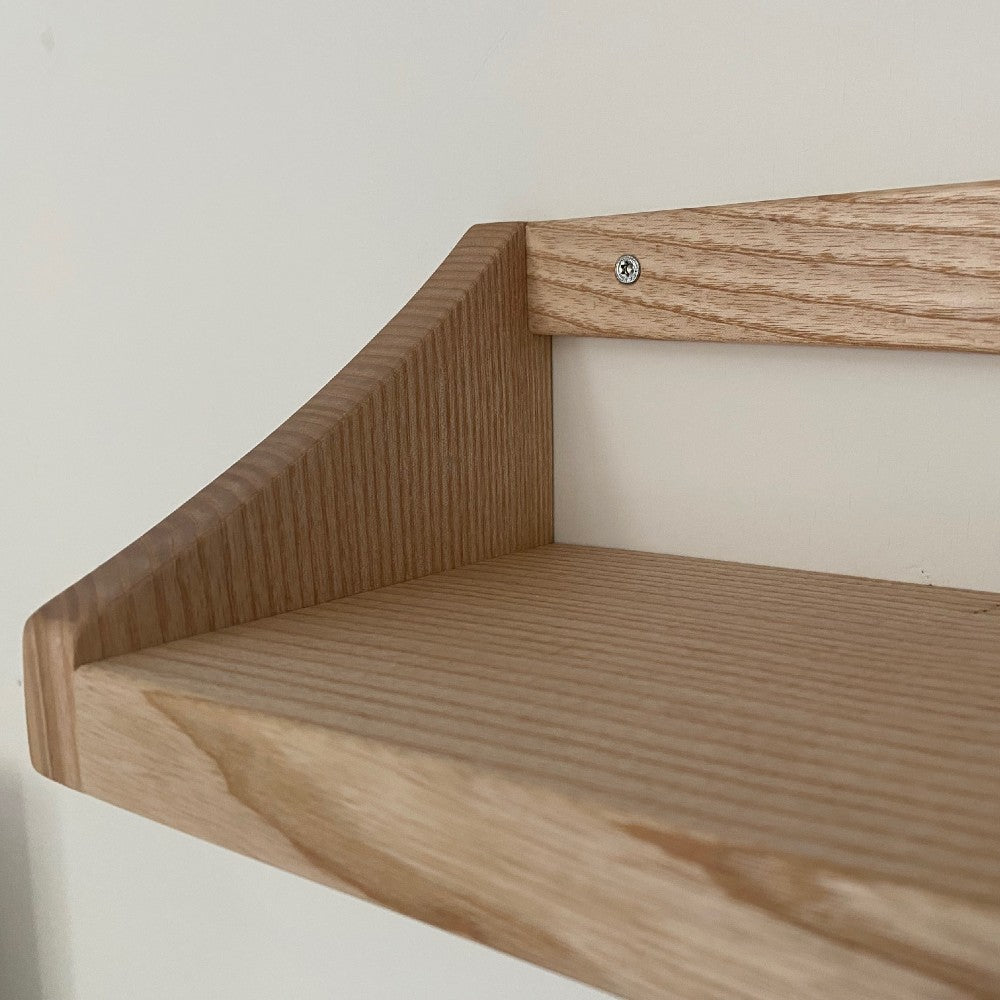 Close up detail of handmade book shelf in British Ash with ends and back plate