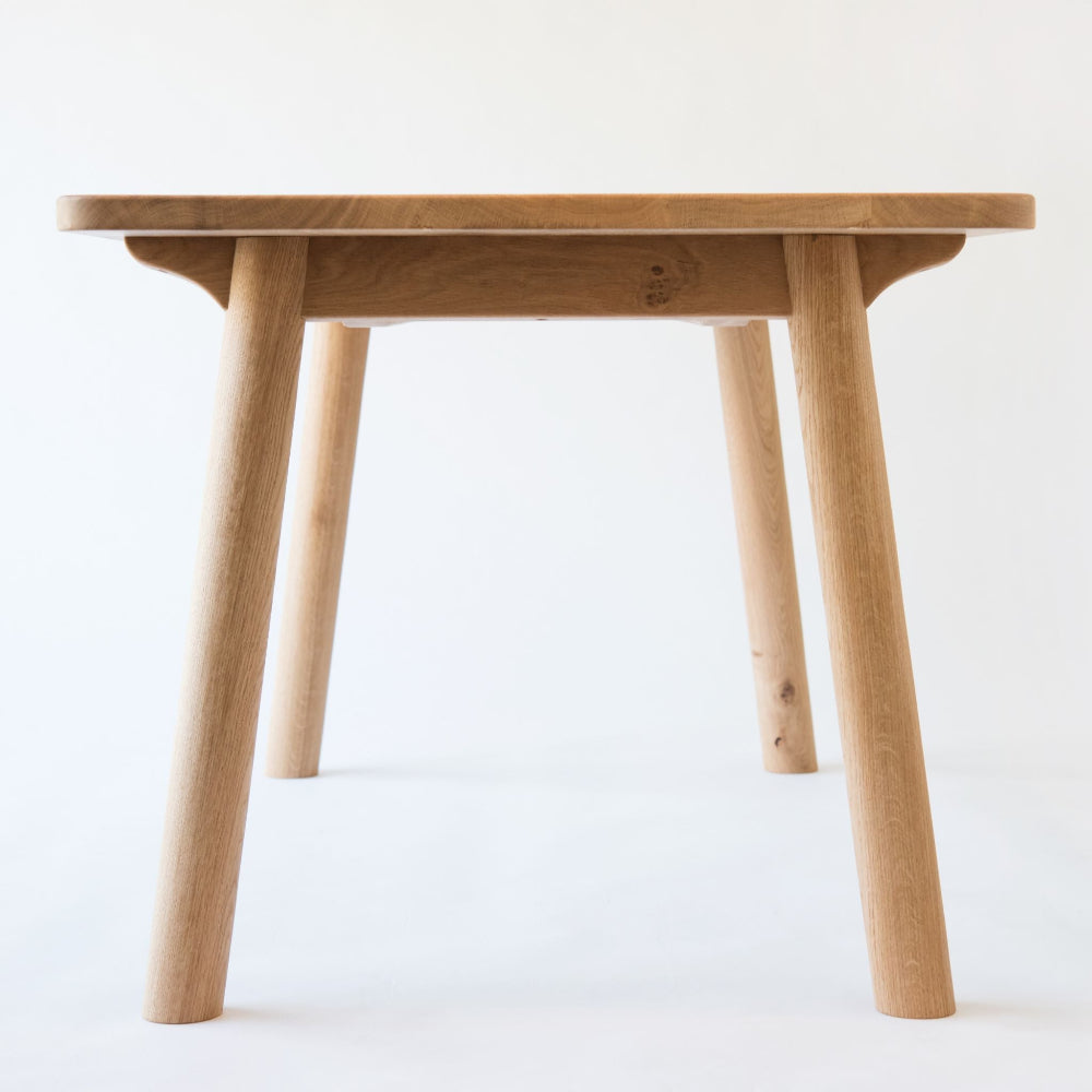 End on view of the Ashridge table in pippy oak