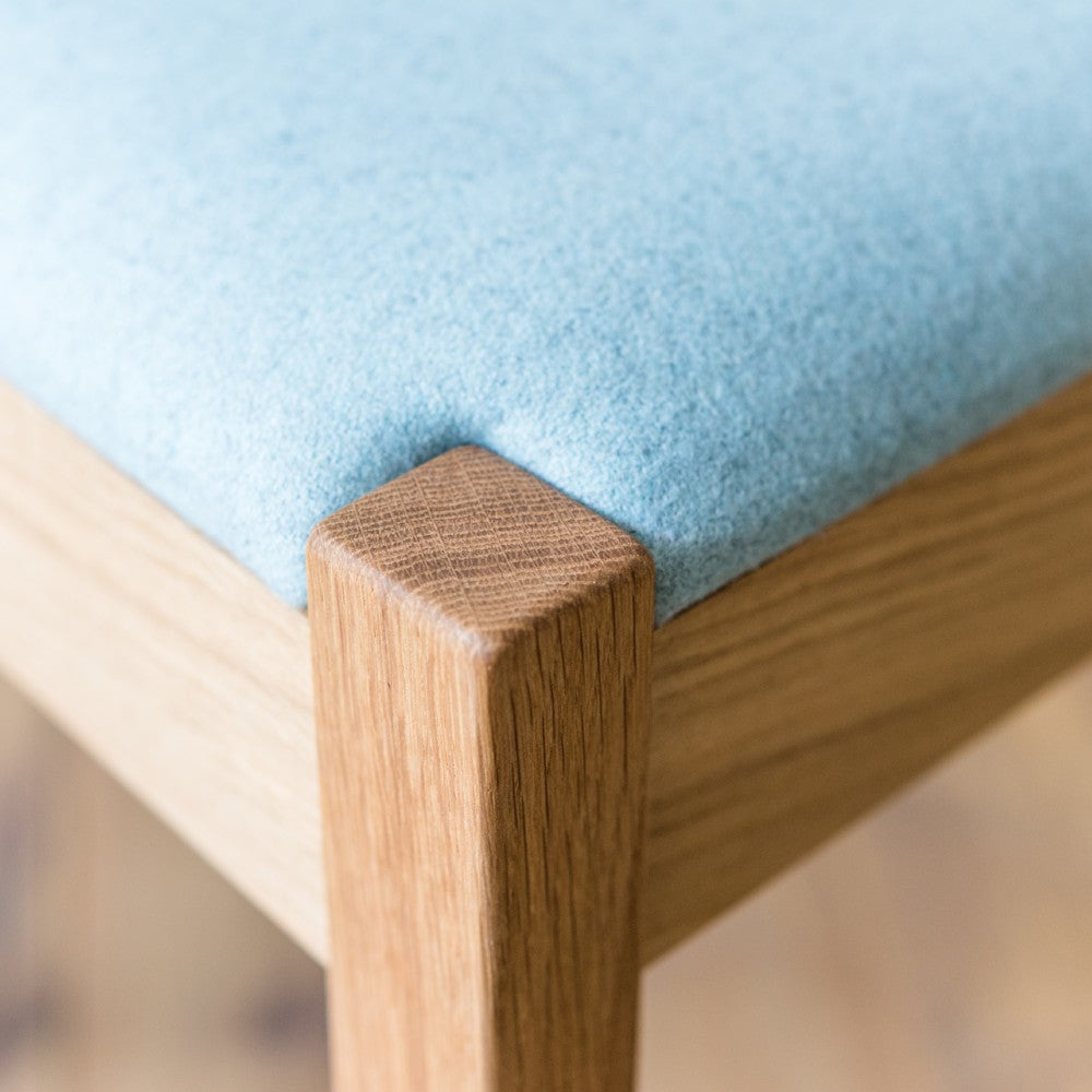 Close up of the Brampton upholstered chair in prime oak with clear oiled finish