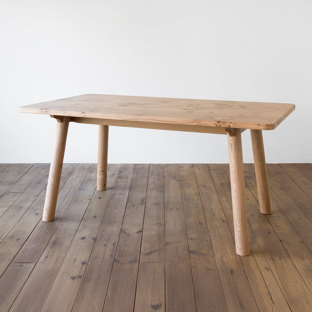 side view of orpago hand made bespoke ashridge kitchen dining table made from british pippy oak with a clear oiled finish
