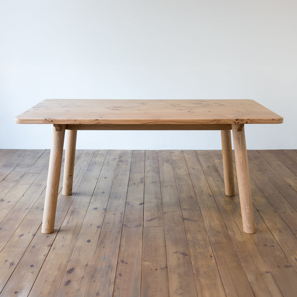 front view of orpago hand made bespoke ashridge kitchen dining table made from british pippy oak with a clear oiled finish