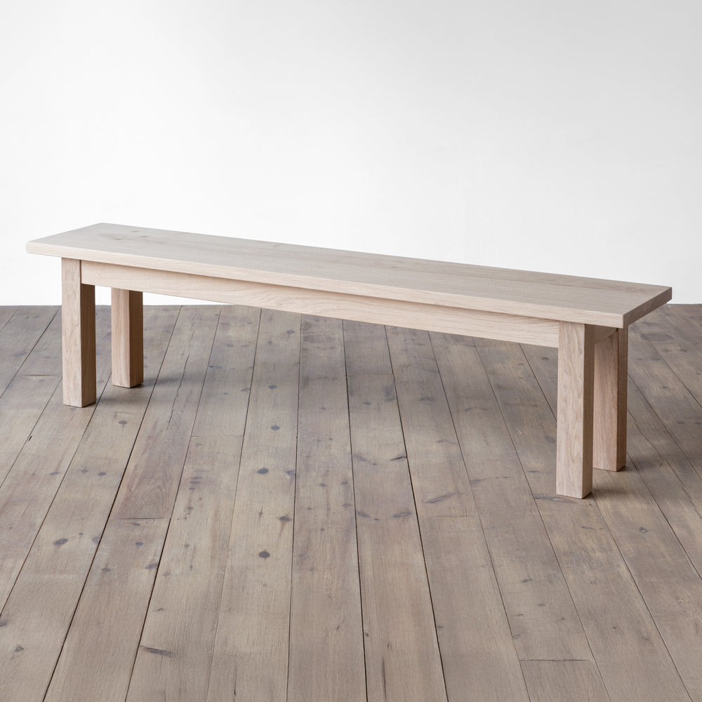 side view of orpago hand made bespoke avon bench made from british prime oak and a raw oiled finish with square legs