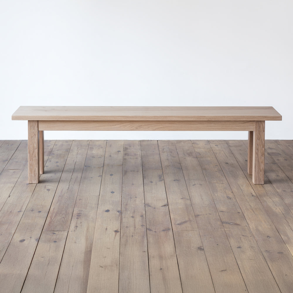 front view of orpago hand made bespoke avon bench made from british prime oak and a raw oiled finish with square legs