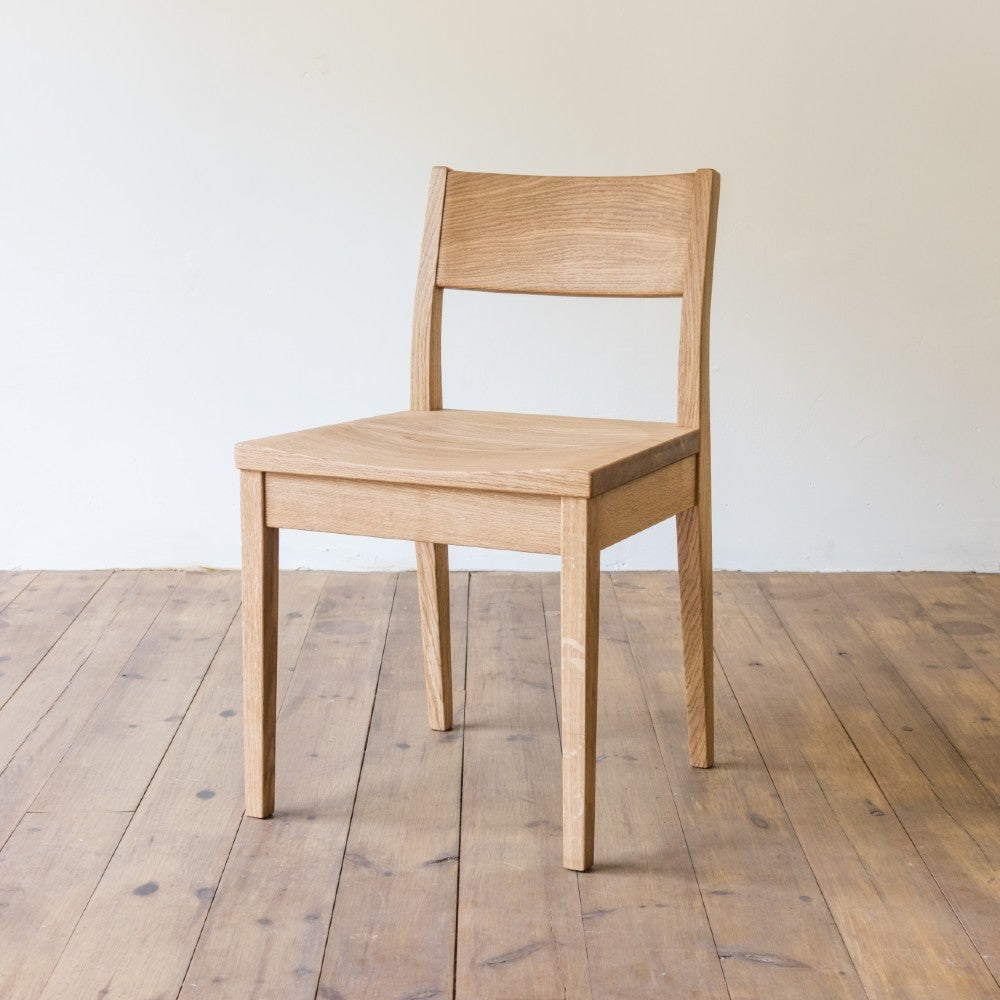 left front and side view of orpago hand made bespoke brampton kitchen dining lowback chair made from oak and a clear oiled finish