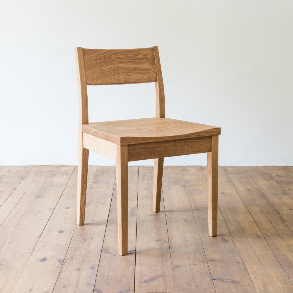 right front and side view of orpago hand made bespoke brampton kitchen dining lowback chair made from oak and a clear oiled finish