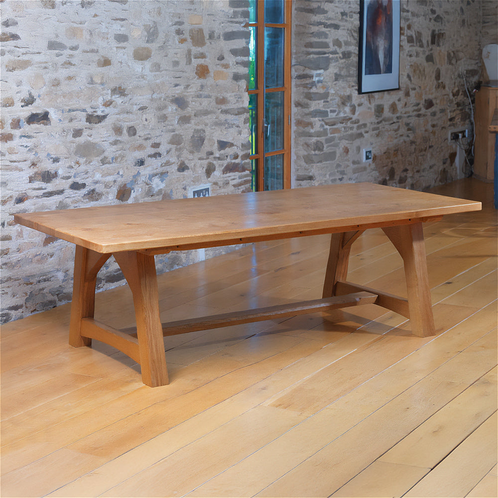 front view of orpago hand made bespoke savernake kitchen dining table made from british oak with distressed edges and a gazelle oiled finish