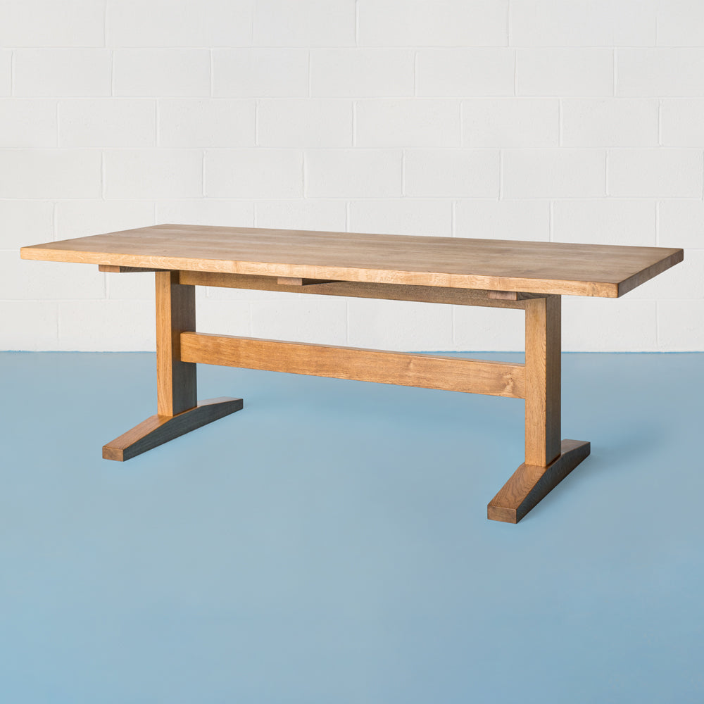 side view of orpago hand made bespoke watkins kitchen dining table made from british pippy oak with breadboard ends and a gazelle oiled finish