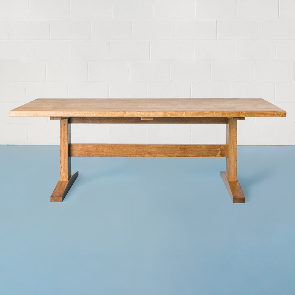 front view of orpago hand made bespoke watkins kitchen dining table made from british pippy oak with breadboard ends and a gazelle oiled finish
