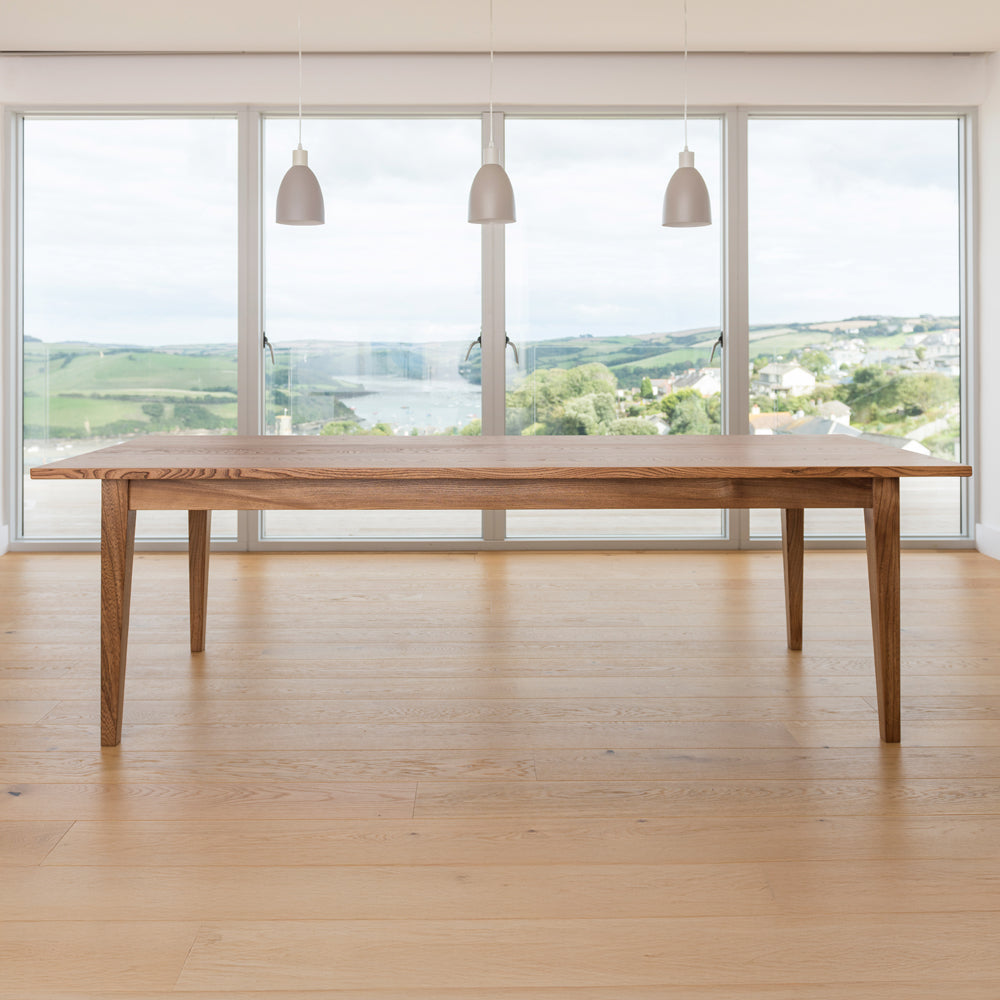 front view of orpago hand made bespoke weaveley kitchen dining table made from british elm and a clear oiled finish