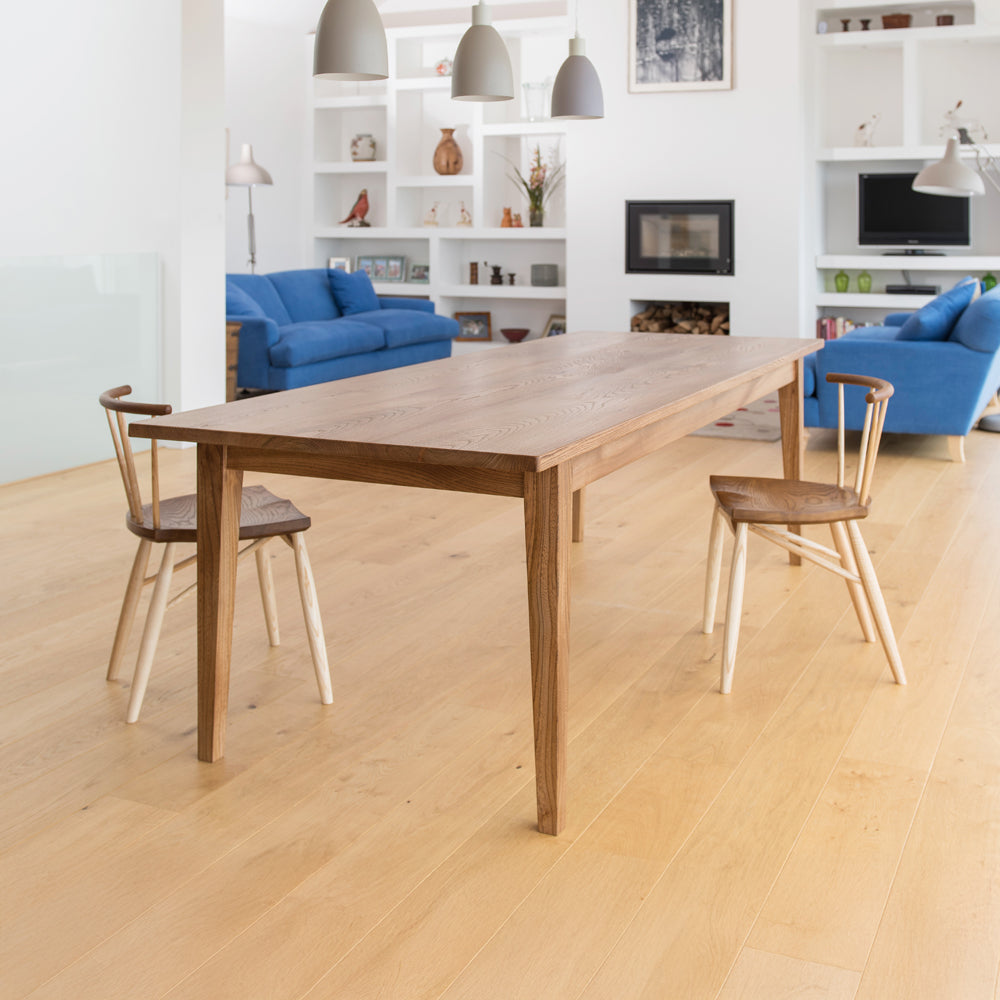 side view of orpago hand made bespoke weaveley kitchen dining table and dining chairs made from british elm and a clear oiled finish