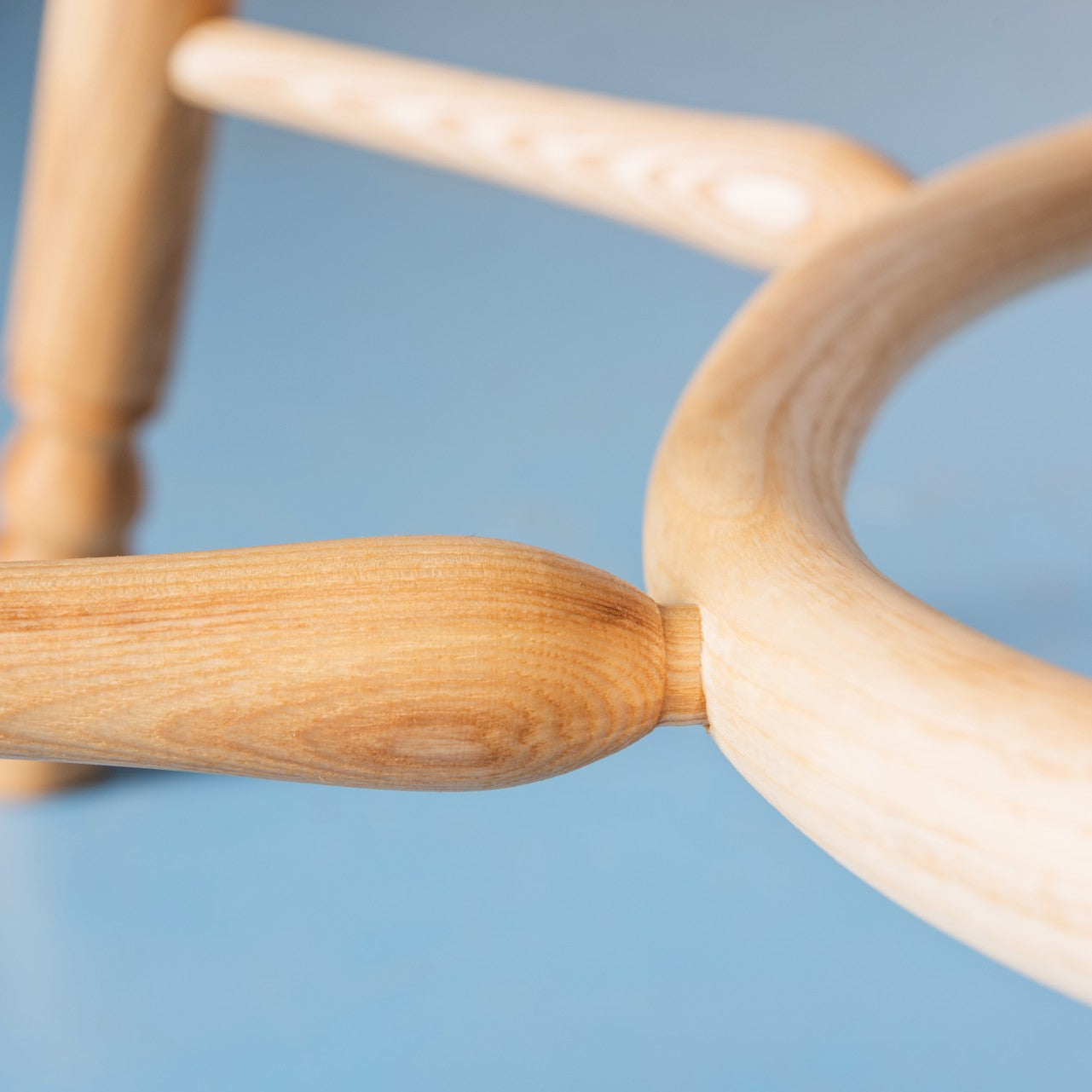 Close up of the crinoline stretcher on our Richmond armchair in ash with a clear satin oiled finish